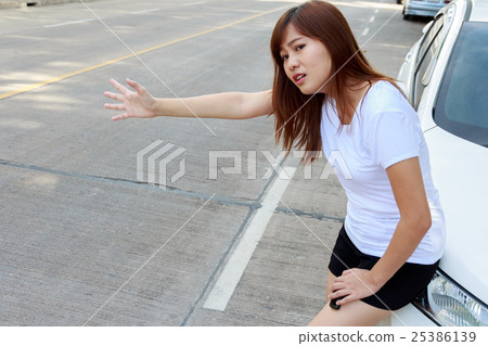 Woman looking for help after a car breakdown Woman looking for help after a car breakdown 25386139