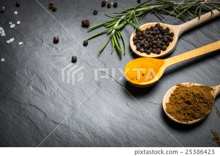 Stock Photo: spices and herbs over black stone background