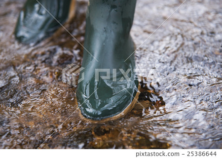 close up on rubber boots in the water close up on rubber boots in the water 25386644