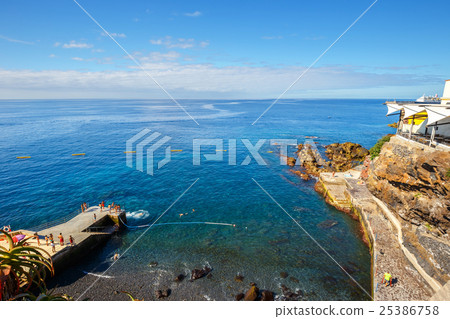 sunbathing on the city beach in Funchal 25386758