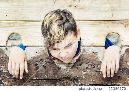 Young caucasian boy in medieval pillory 25386870