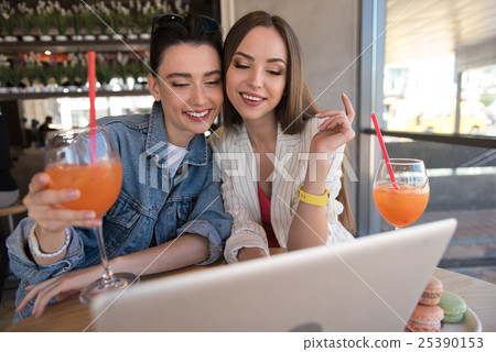 girls enjoying being together in a cafe 25390153