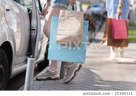 girl sitting in a car with her purchases girl sitting in a car with her purchases 25390311