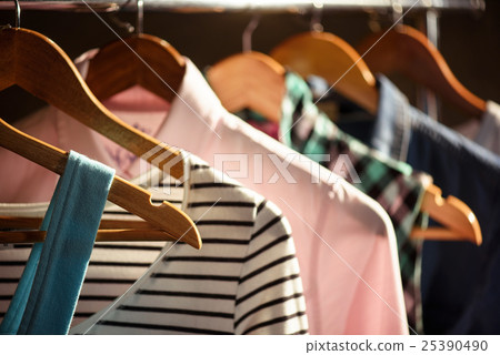 Trendy clothing on wooden hangers 25390490