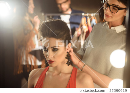 Cheerful creative team working in photo studio Cheerful creative team working in photo studio 25390619