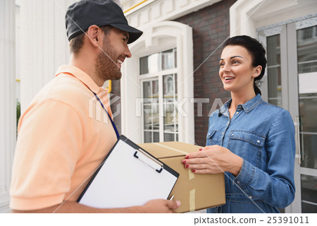 Courier making delivery to beautiful woman Courier making delivery to beautiful woman 25391011