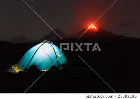 Illuminated tourist tent on background volcano Illuminated tourist tent on background volcano 25392190