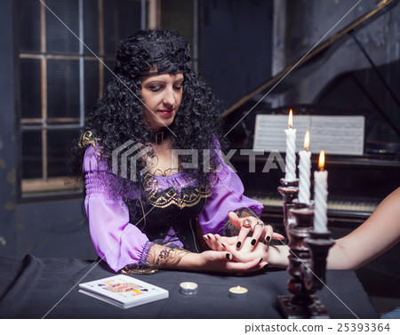 Sorceress reading somebody's hand 25393364