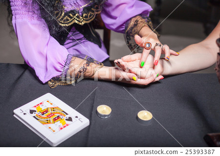 Sorceress reading somebody's hand 25393387
