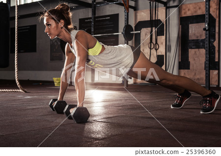 Female exercising at gym. 25396360