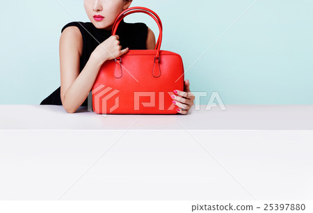 Red leather bag and female shopping image Copy space on wall and table 25397880