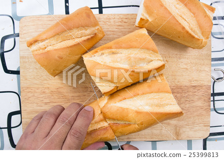 Chef slicing bread 25399813