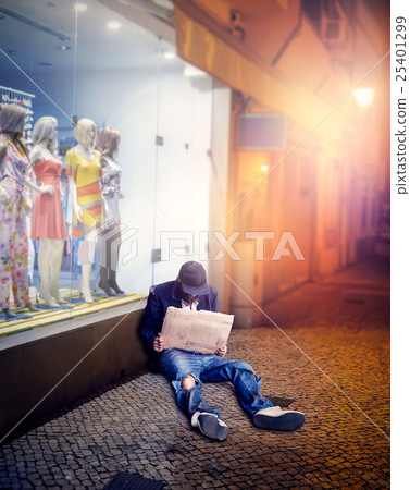 Vagrant sitting near the shop 25401299