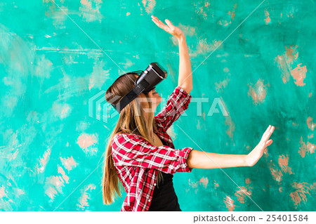 Woman touching something using virtual reality 25401584