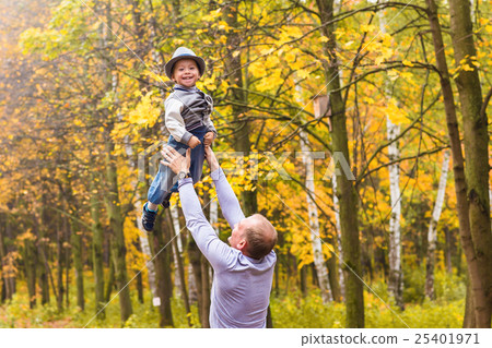 Father throws his happy laughing son in the air in 25401971