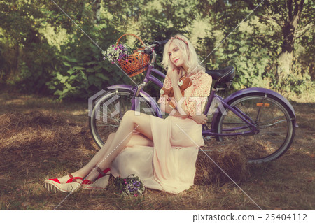 Girl hugging a toy bear in the park. 25404112