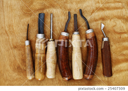 carving tool closeup on wooden background 25407309