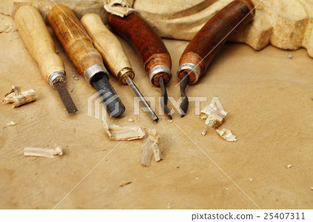 carving tool closeup on wooden background 25407311
