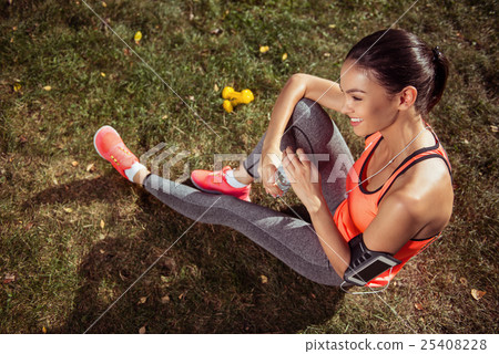 Laughing girl holding the bottle of water after 25408228