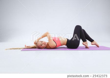 Stretching in the white studio 25412373