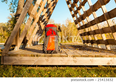 Tourist backpack lies on the edge of hut, in light 25413832