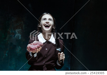 Bloody Halloween theme: crazy girl with a knife Bloody Halloween theme: crazy girl with a knife 25419305