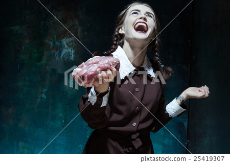 Bloody Halloween theme: crazy girl with raw meat Bloody Halloween theme: crazy girl with raw meat 25419307