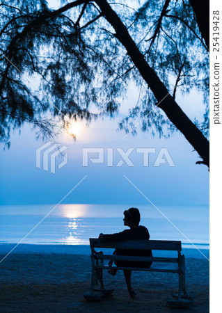 Woman at night with the moon on the Beach Woman at night with the moon on the Beach 25419428