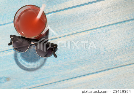 smiley drink on beach table 25419594