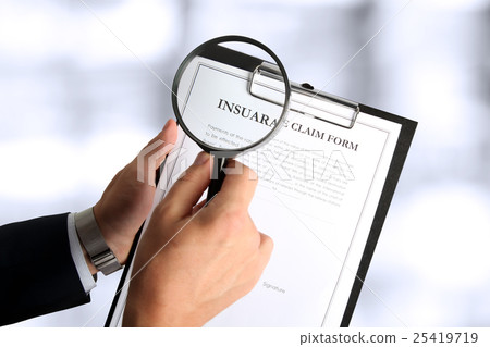 Man looking through a magnifying glass  Insurance 25419719