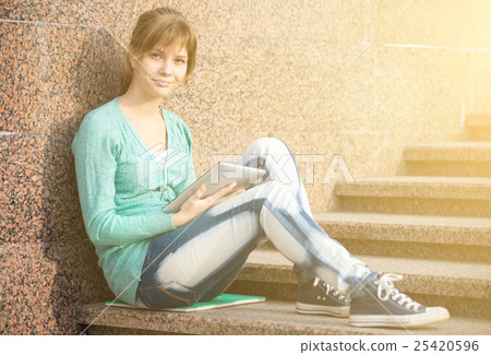 Beautiful young woman student with note pad Beautiful young woman student with note pad 25420596