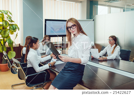 Beautiful business woman in glasses on the team's 25422627