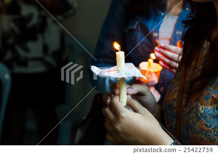People holding candle vigil in dark seeking hope 25422739