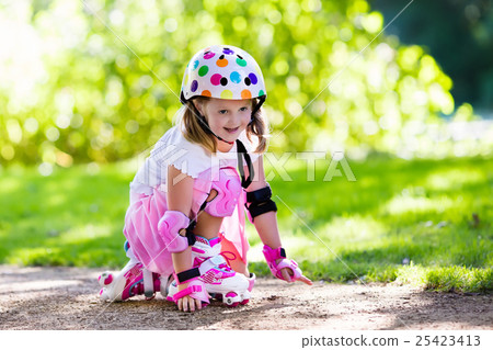 Little girl with roller skate shoes in a park Little girl with roller skate shoes in a park 25423413