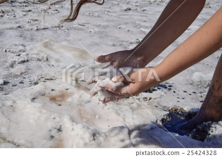 Hands girls taking on the wet salt Hands girls taking on the wet salt 25424328