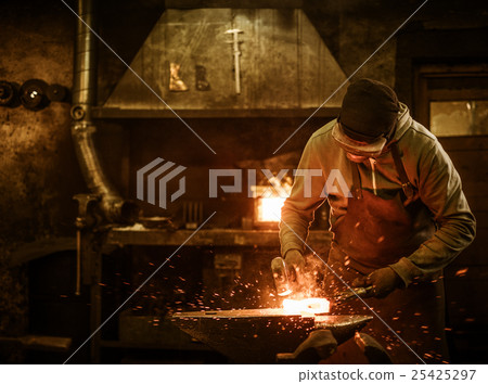 The blacksmith forging the molten metal on the 25425297