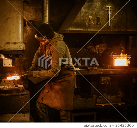 The blacksmith forging the molten metal on the 25425300