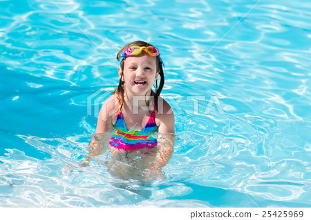 Child learning to swim in pool 25425969