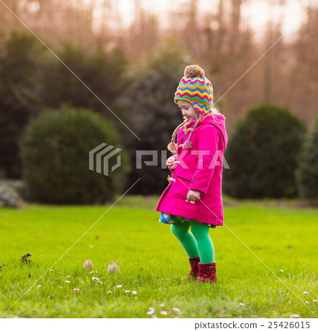 Little girl playing in autumn park Little girl playing in autumn park 25426015