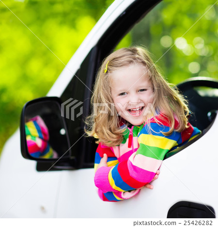Little girl sitting in white car Little girl sitting in white car 25426282