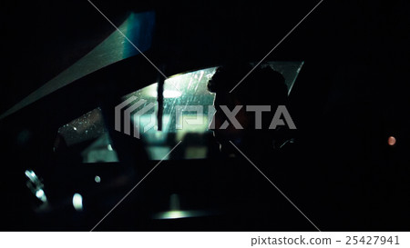 Profile of a man in car on dark night. Profile of a man in car on dark night. 25427941
