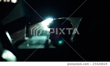 Profile of a man in car on dark night. Profile of a man in car on dark night. 25428024