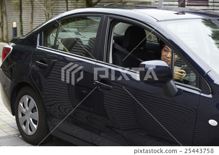 A woman driving a car 25443758