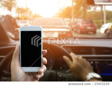 Using a smartphone while driving a car 25453259