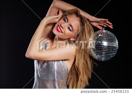 Woman with fashion makeup holding disco ball 25456133