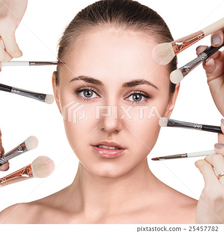 Woman with make-up brushes near face 25457782