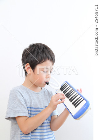Elementary school student practicing keyboard harmonica 25458711
