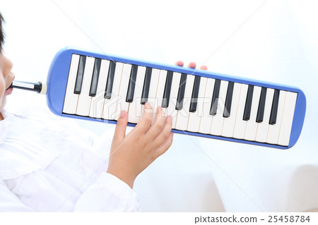 Elementary school student practicing keyboard harmonica 25458784