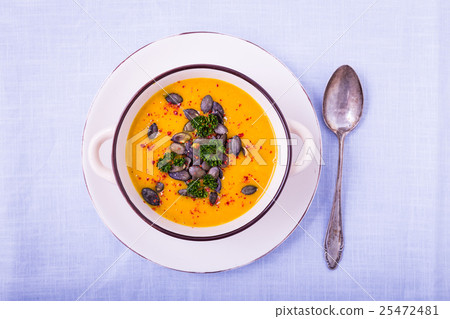 Pumpkin soup with pumpkin seeds and chili peppers 25472481
