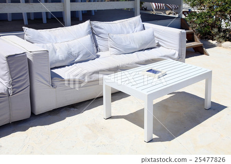 Terrace lounge with white sofa in a summer resort Terrace lounge with white sofa in a summer resort 25477826